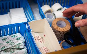 Medical supplies such as bandages and tape pictured in a drawer